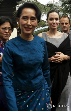 Myanmar pro-democracy leader Aung San Suu Kyi and UNHCR special envoy Angelina Jolie Pitt arrive at a hostel for female factory workers in the Hlaingtaryar Industrial Zone in Yangon